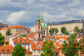 Obraz premium Mala Strana old district with St Nicholas Church baroque dome and clocktower in Prague