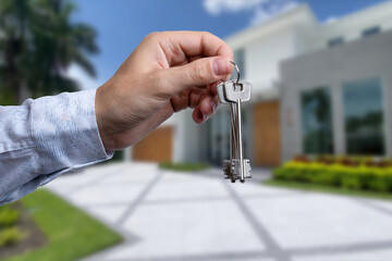 Man hand holding on finger keys to new house.