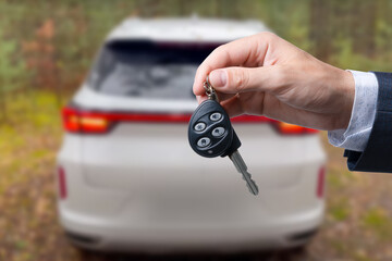 Close-up of dealer handing keys to new owners at a car show Automotive business Car sales Agreement Concept Men car salesman handing over new car keys.