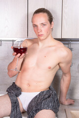 Young sexy guy in the kitchen.