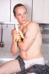 Young sexy guy in the kitchen.