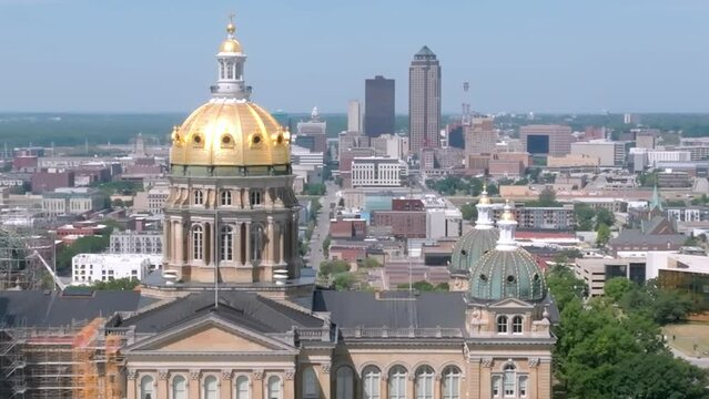 Iowa state capitol building in Des Moines, Iowa with drone video moving in close up parallax with Des Moines skyline.