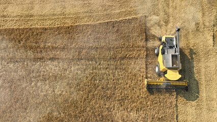 harvester working in a grain field, from the top