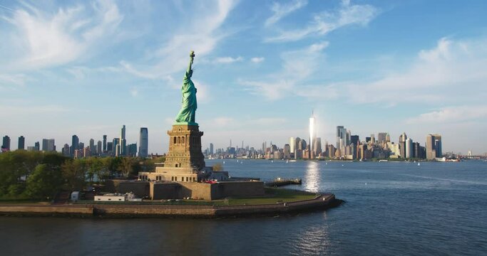 Aerial Hyperlapse Footage Passing the Statue of Liberty with Lower Manhattan Skyline Cityscape with Wall Street Office Architecture. Moving Time-Lapse of New York City Skyscrapers and Jersey City