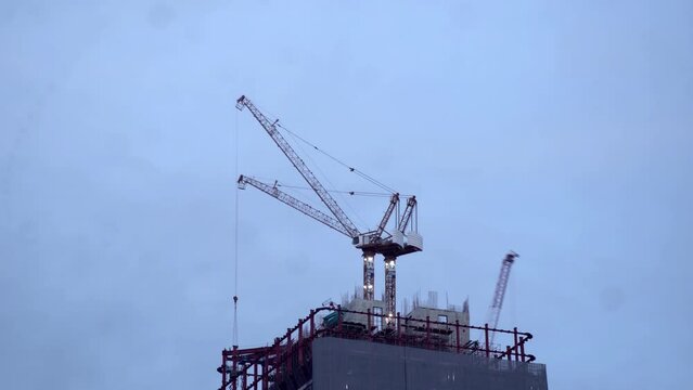 Time lapse of crane moving at a construction site.