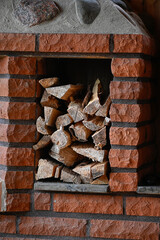 fireplace made of bricks with piled firewood