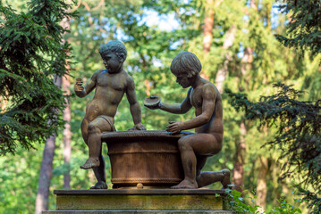 Bronze youth on a gravestone of the southwest churchyard Stahnsdorf, a famous woodland- and also a celebrity cemetery in the federal state of Brandenburg in the south of Berlin
