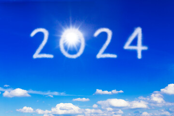 Happy New Year 2024 concept: the number 2024 written on blue sky with a brightly shining sun, symbol for an optimistic outlook on a bright future.