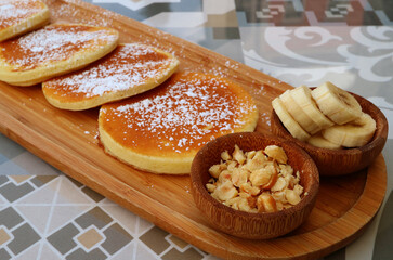 Closeup of chopped nuts with sliced bananas, healthy toppings of pancaked