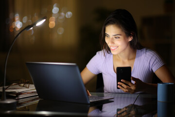 Woman using several devices in the night at home
