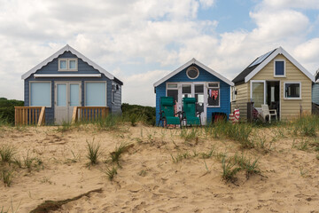 Fototapeta na wymiar Hengistbury Head, UK - July 1st 2023: Beach huts on Mudeford Sandbank.