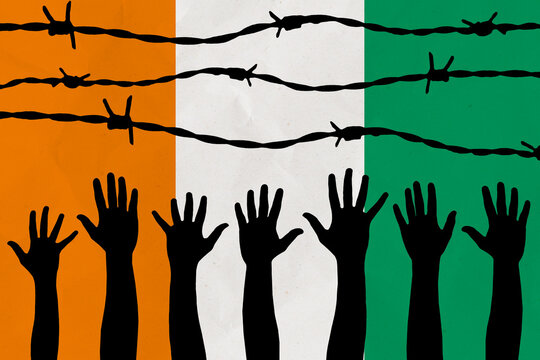 C&ocirc;te d'Ivoire flag behind barbed wire fence. Group of people hands. Freedom and propaganda concept