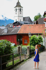 Fototapeta na wymiar girl walking in the alpine village St. Wolfgang
