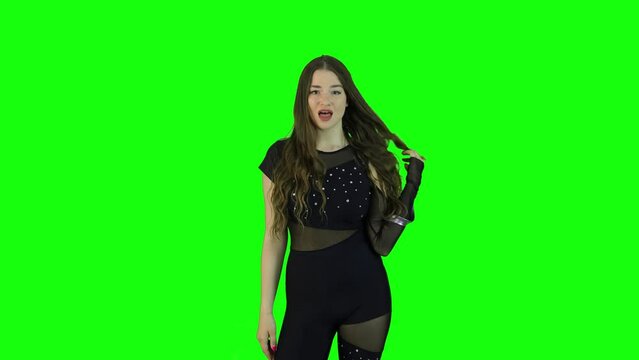 Stunning female model acting in front of a green screen