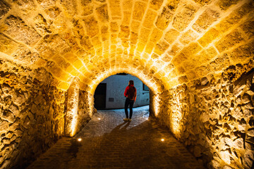 illuminated tunnel at night