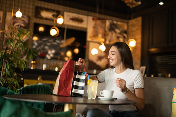 woman in cafe after shopping rest