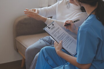 Doctor and patient talking while sitting at the desk in hospital office, closeup of human hands. Medicine and health care concept