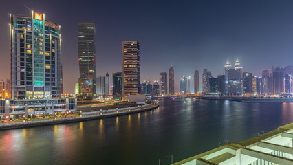 Modern city architecture in Business bay district. Panoramic view of Dubai's skyscrapers day to night timelapse