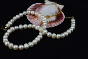 Women's jewelry in the form of natural pearl beads on a black background