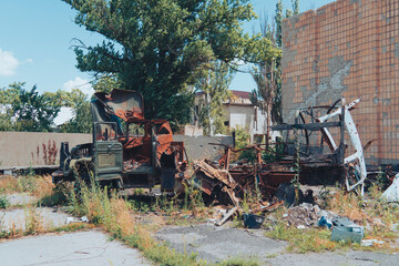 Fototapeta premium A destroyed military truck stands on a city street. War in Ukraine