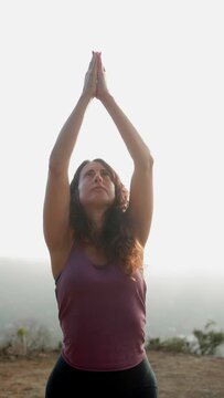 Female yogi doing meditation yoga routine outdoors - healthcare and mindfulness concept