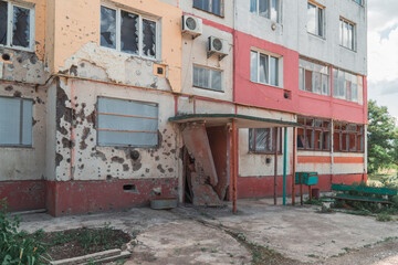 Entrance of a residential building destroyed by shelling. War in Ukraine