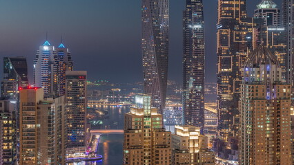 Fototapeta na wymiar Skyscrapers of Dubai Marina near intersection on Sheikh Zayed Road with highest residential buildings day to night timelapse