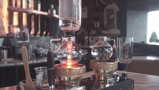 Preparing coffee with syphon at coffee shop.