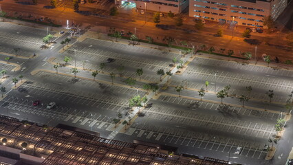 Big parking lot near mall crowded by many cars timelapse aerial view