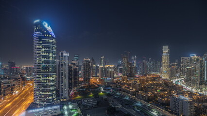 Panorama showing Dubai Downtown and business bay night timelapse with tallest skyscraper and other towers