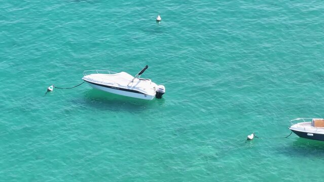 Anchored motorboats at blueish turquoise waters of Lido Galeazzi Italy 
