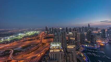 Fototapeta na wymiar Dubai marina and JLT skyscrapers along Sheikh Zayed Road aerial day to night timelapse.