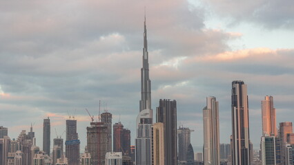 Fototapeta premium Panoramic skyline of Dubai with business bay and downtown district night to day timelapse.