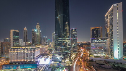 Fototapeta na wymiar Dubai International Financial district aerial day to night timelapse. Panoramic view of business and financial office towers.