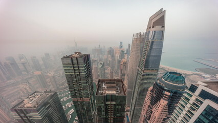 Skyline panoramic view of Dubai Marina showing canal surrounded by skyscrapers along shoreline...