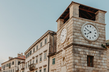 The clock tower on the army square at the entrance gate in the medieval city of Kotor. Evening...