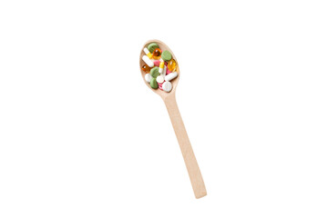 Vitamin capsules in a wooden spoon on a colored background. Pills served as a healthy meal. Drugs, pharmacy, medicine or medical healthycare concept