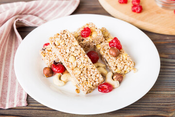 Various granola bars on table background. Cereal granola bars. Superfood breakfast bars with oats, nuts and berries, close up. Superfood concept