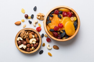 healthy snack: mixed nuts and dried fruits in bowl on table background, almond, pineapple, cranberry, cherry, apricot, cashew