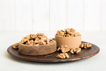 Fresh healthy walnuts in bowl on colored table background. Top view Healthy eating bertholletia concept. Super foods