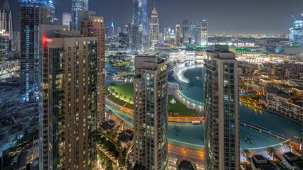 Fototapeta na wymiar Panorama showing Dubai Downtown cityscape with tallest skyscrapers around aerial night timelapse.