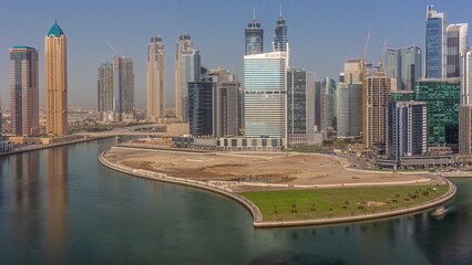 Fototapeta premium Cityscape skyscrapers of Dubai Business Bay with water canal aerial timelapse.