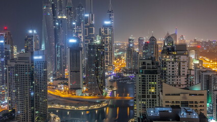 View of various skyscrapers in tallest recidential block in Dubai Marina aerial all night timelapse