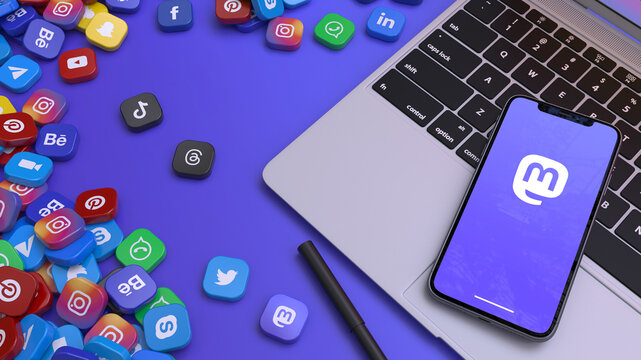 3D rendering of a smart phone showing the icon of Mastodon on a laptop surrounded by the most important social networks' badges.