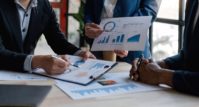 Asian business advisor meeting to analyze and discuss the situation on the financial report in the meeting room. Investment Consultant, Financial , teamwork ,brainstorming ,startup and accounting
