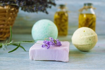 Lavender soap and lavender flowers on a blue wooden background, natural cosmetics, spa, body care