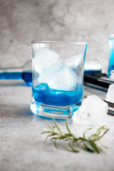 A glass of cocktail, Blue Lagoon. cool. on a gray background
