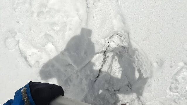 The climber goes up the slope and breaks into the snow. View down on the legs. First-person view. Climbing Belukha. Ice classes. Beautiful nature of Altai, Russia.