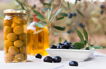 canned olives in a glass jar, butter and olives on the table