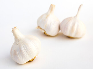 garlic heads and cloves on white background